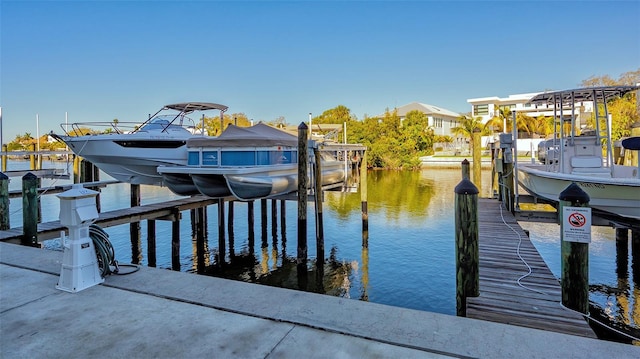 dock area with a water view and boat lift