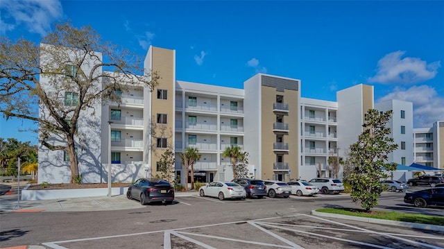 view of building exterior featuring uncovered parking