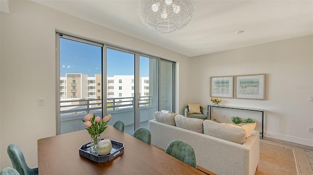 dining space with a notable chandelier, a view of city, and baseboards