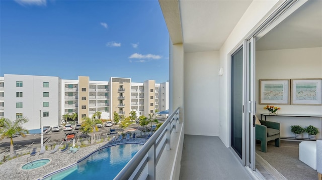 balcony featuring a community pool