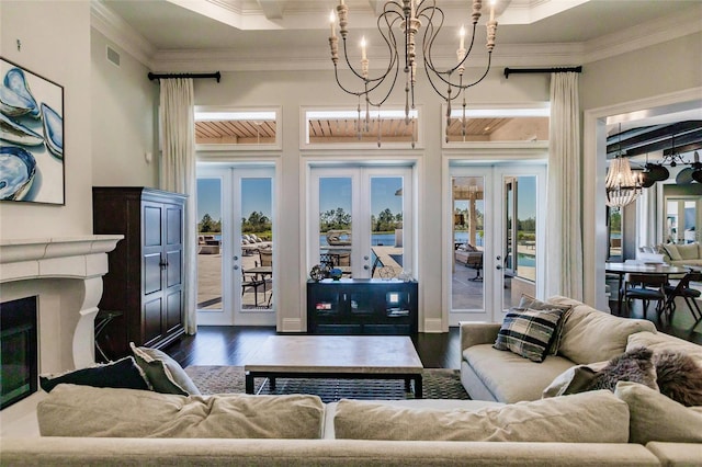 living room featuring a chandelier, french doors, dark hardwood / wood-style flooring, and ornamental molding