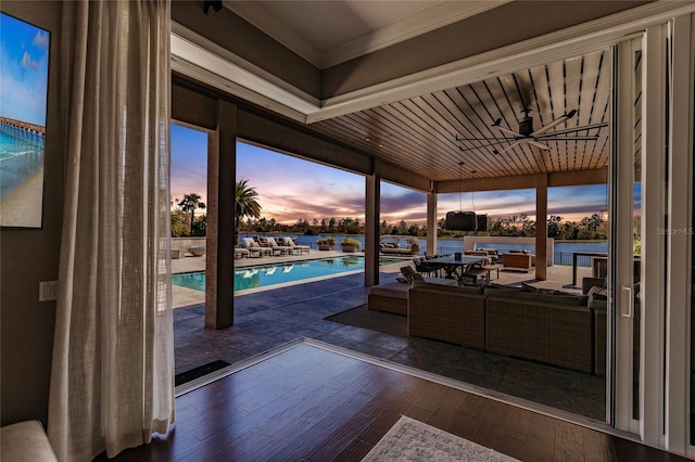 patio terrace at dusk with an outdoor living space and ceiling fan