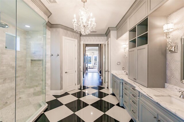 bathroom with vanity, ornamental molding, tiled shower, and an inviting chandelier