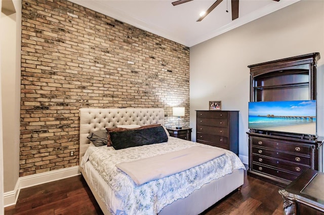 bedroom featuring dark hardwood / wood-style flooring, ceiling fan, ornamental molding, and brick wall