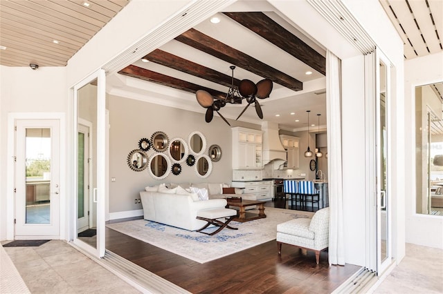 living room featuring a notable chandelier, light hardwood / wood-style floors, and beam ceiling