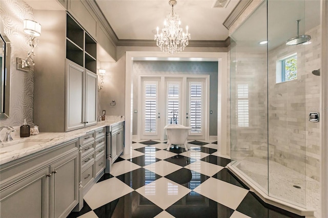 bathroom featuring a tile shower, french doors, an inviting chandelier, vanity, and ornamental molding