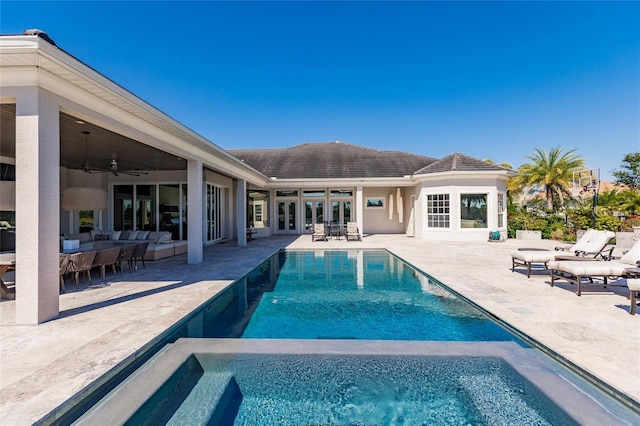 view of swimming pool with ceiling fan and a patio