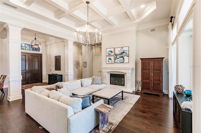 living room with beam ceiling, a high ceiling, an inviting chandelier, dark hardwood / wood-style flooring, and crown molding