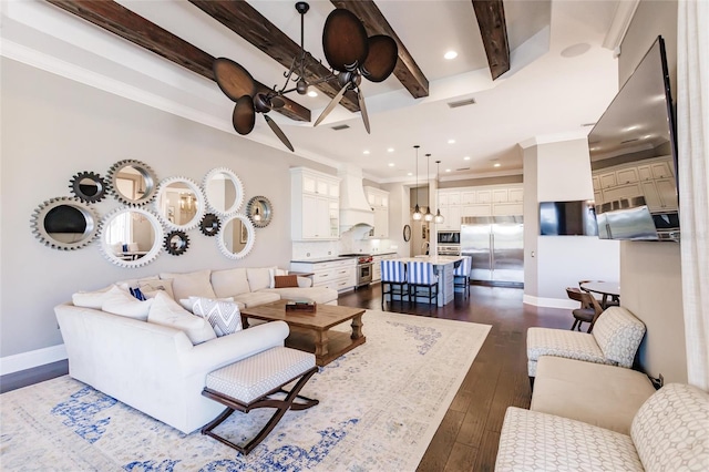 living room featuring beamed ceiling, crown molding, ceiling fan, and dark wood-type flooring