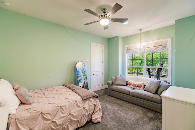 bedroom with carpet and ceiling fan with notable chandelier