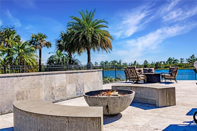 view of patio featuring a water view and a fire pit