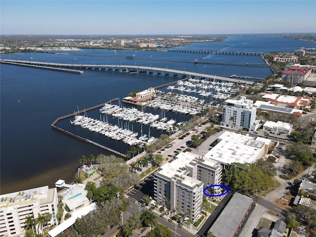 birds eye view of property with a water view and a city view