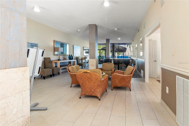 living area featuring visible vents and light tile patterned flooring