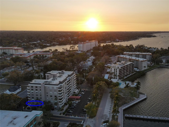 aerial view at dusk with a view of city and a water view