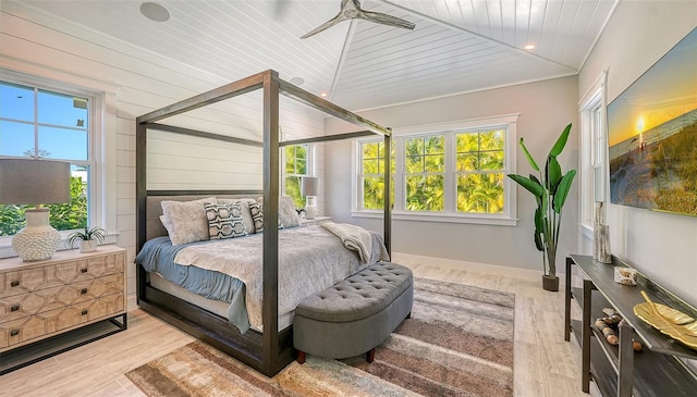 bedroom with ceiling fan, light wood-type flooring, wood ceiling, and multiple windows