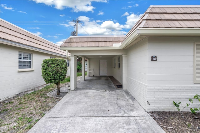 view of exterior entry featuring a carport