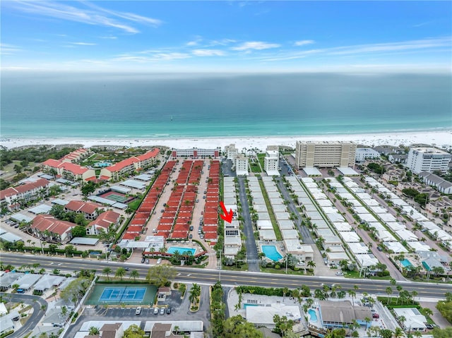 bird's eye view with a water view and a beach view