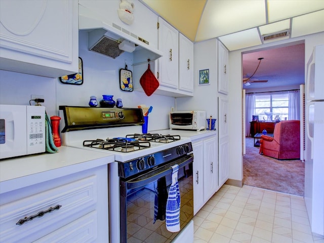 kitchen featuring ceiling fan, extractor fan, light colored carpet, white appliances, and white cabinets