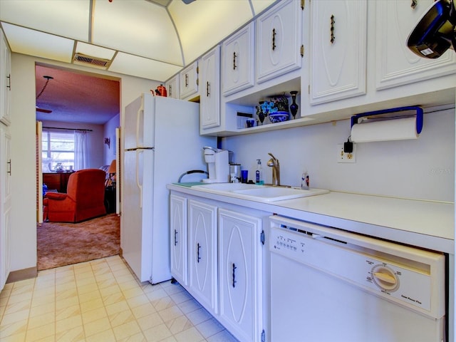 kitchen with white cabinetry, sink, white appliances, and light carpet