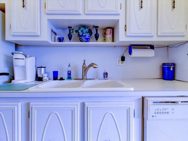 kitchen featuring white cabinets, sink, and white dishwasher