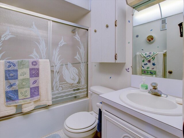 full bathroom with vanity, toilet, and bath / shower combo with glass door