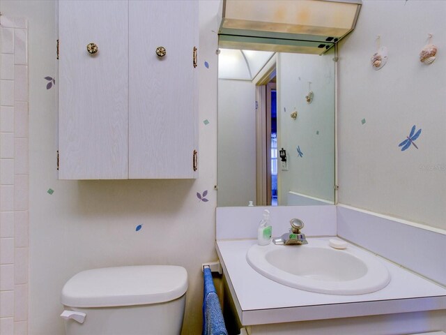 bathroom featuring vanity and toilet