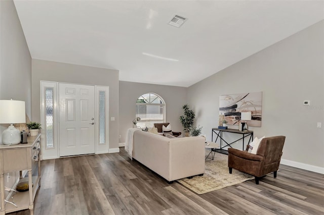 living room featuring dark hardwood / wood-style floors and lofted ceiling