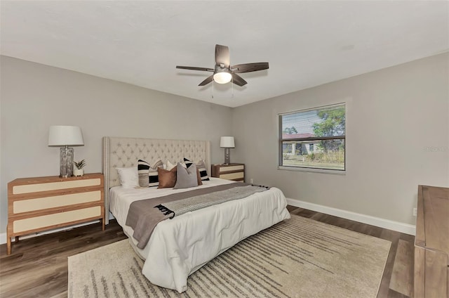 bedroom with ceiling fan and dark hardwood / wood-style flooring