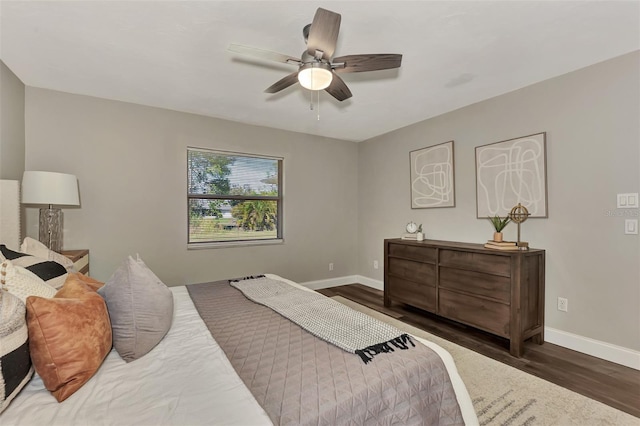 bedroom featuring ceiling fan and dark hardwood / wood-style flooring