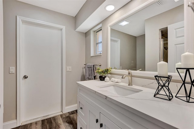 bathroom with vanity and hardwood / wood-style flooring