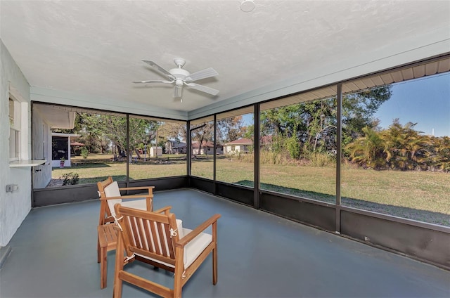 sunroom featuring a healthy amount of sunlight and ceiling fan