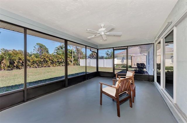 unfurnished sunroom with ceiling fan