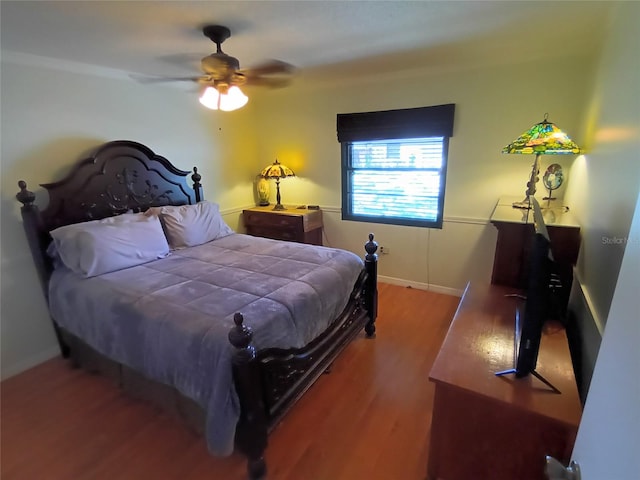 bedroom featuring hardwood / wood-style floors and ceiling fan