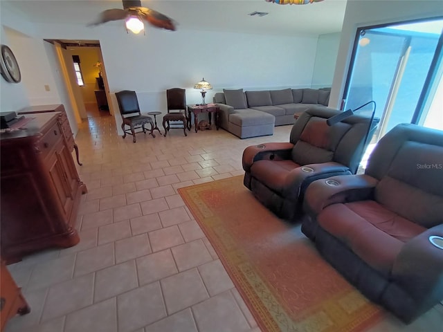 living room with ceiling fan and light tile patterned floors