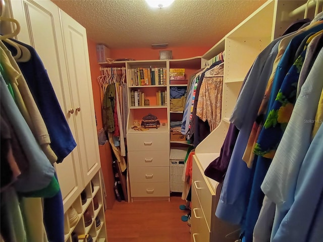 spacious closet with light hardwood / wood-style floors