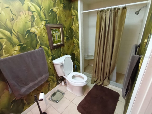 bathroom featuring tile patterned flooring, toilet, and curtained shower