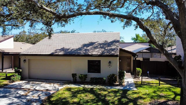 ranch-style home featuring a front lawn and a garage