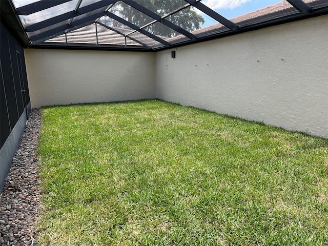 view of yard featuring glass enclosure