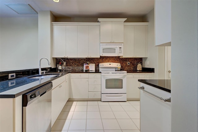 kitchen with light tile floors, white appliances, white cabinets, backsplash, and sink