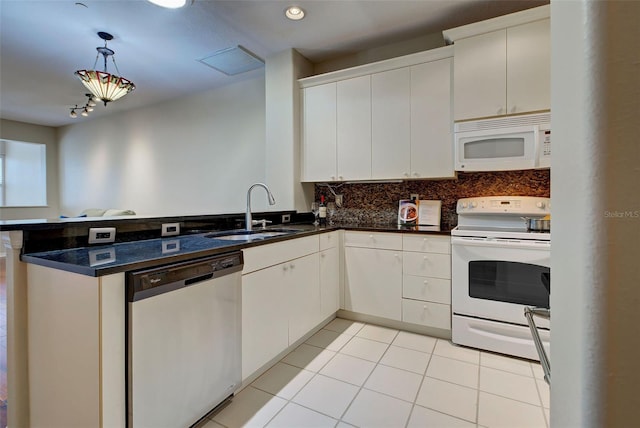 kitchen with light tile floors, kitchen peninsula, white appliances, hanging light fixtures, and sink