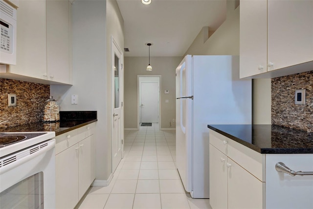 kitchen with white cabinetry, hanging light fixtures, and backsplash