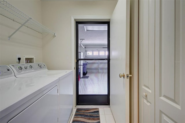 laundry area with light tile floors, separate washer and dryer, and hookup for a washing machine