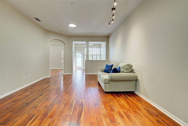 sitting room featuring ceiling fan, track lighting, and hardwood / wood-style flooring