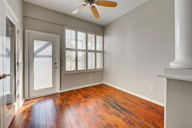 unfurnished room featuring dark wood-type flooring and ceiling fan