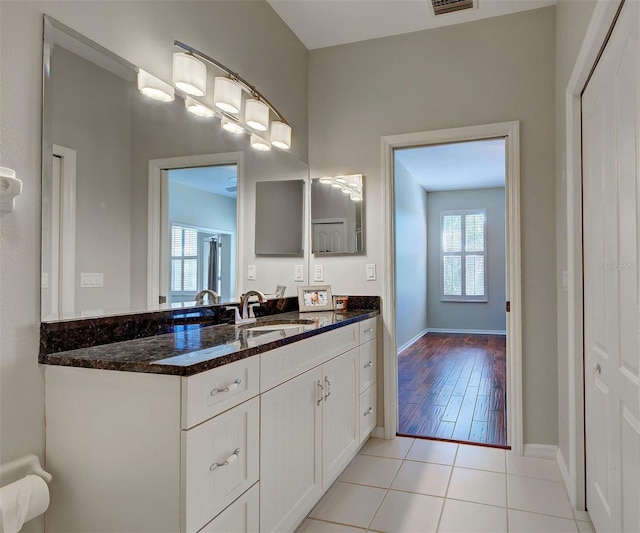 bathroom featuring tile flooring, vanity, and a wealth of natural light