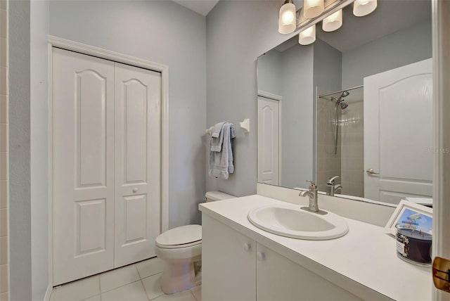 bathroom with toilet, tile flooring, and vanity