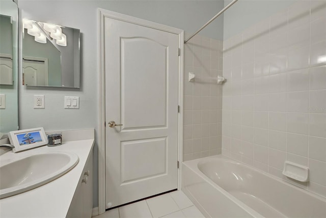 bathroom featuring large vanity, tile floors, and tiled shower / bath combo