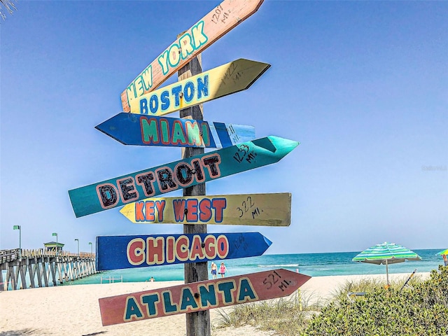 community / neighborhood sign featuring a water view