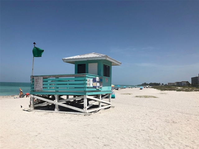 view of nearby features with a view of the beach and a water view