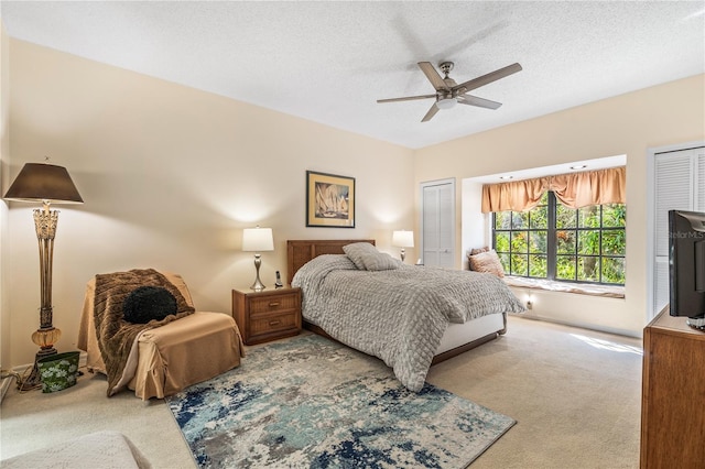 bedroom with carpet flooring, a textured ceiling, and ceiling fan